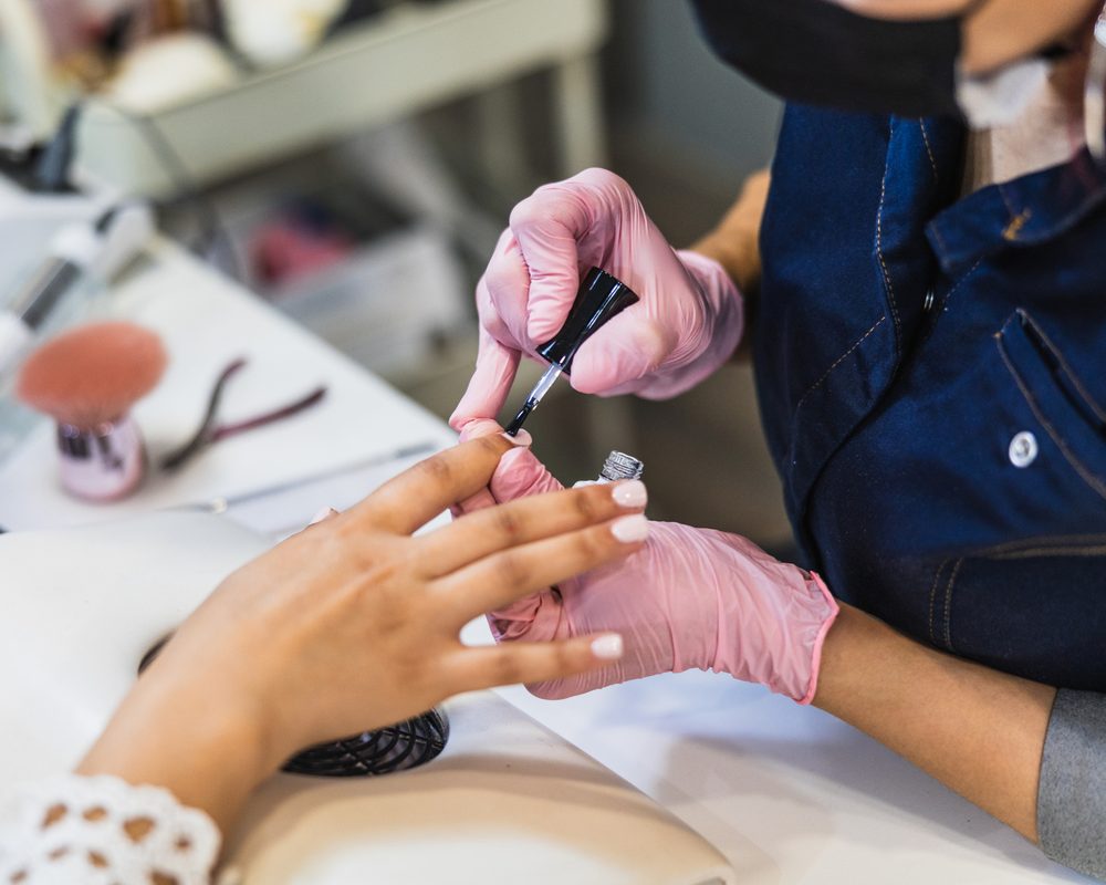 Nail polish being applied during a manicure